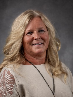 Councillor Deb gilvesy, with mid shoulder length blond hair wearing a  light cream coloured top